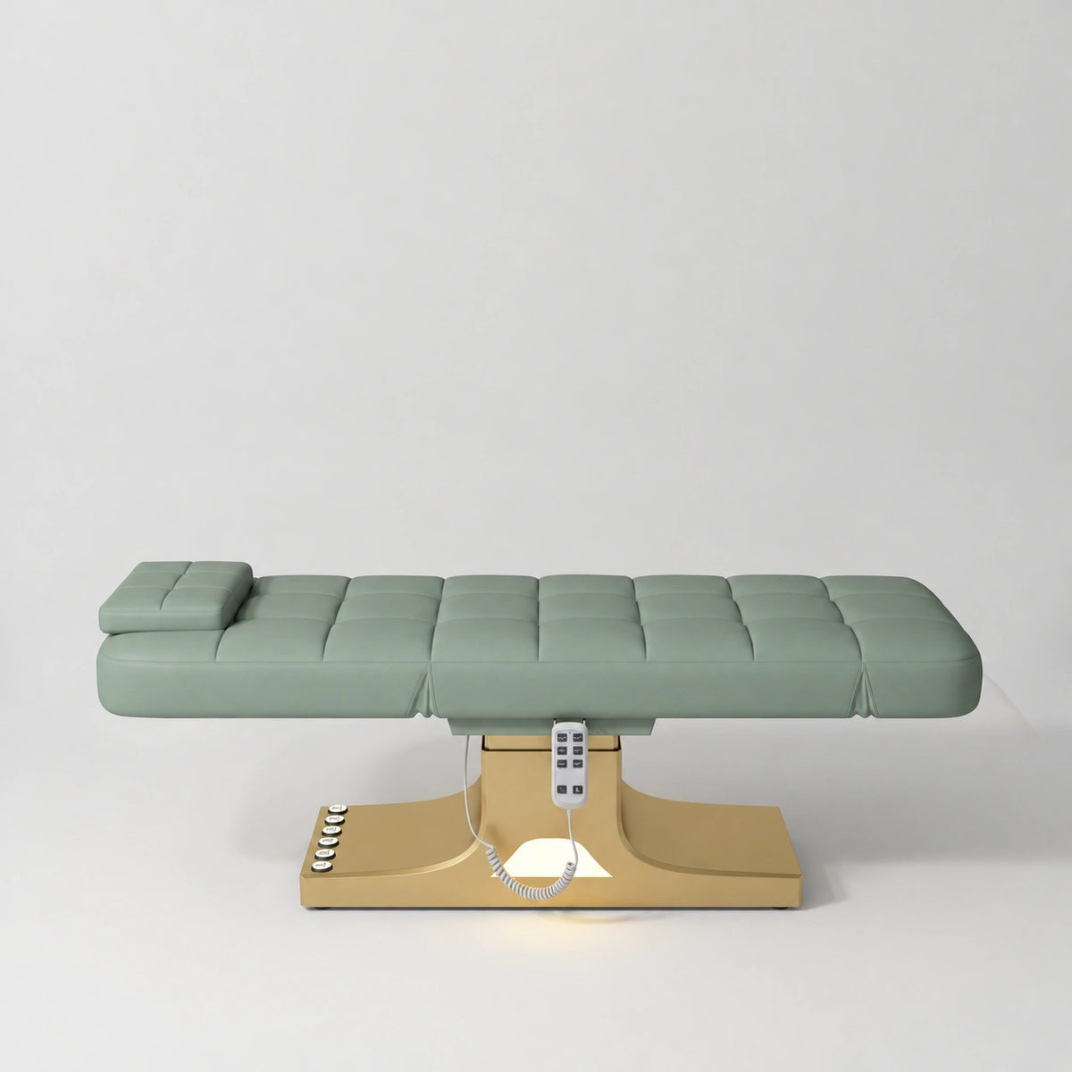 Manufakturo Saphir A Olive electric beauty bed with gold base, flat lying position shown from the side, without armrests.