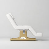 Manufakturo Saphir A White electric beauty bed with gold base, raised treatment position shown from the side, without armrests.