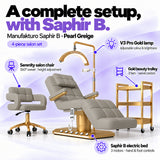 Manufakturo Saphir B Pearl Greige set features: three-motor bed with hand and foot controls, Serenity swivel chair, adjustable V3 Pro Gold lamp and three-tier gold trolley.