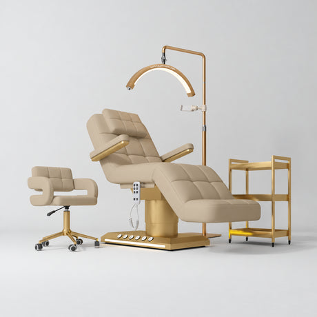 Manufakturo Saphir B Warm Beige four-piece beauty studio set with armrest electric bed, Serenity salon chair, V3 Pro Gold lamp and empty three-tier gold trolley.