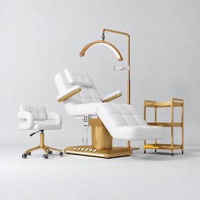 Manufakturo Saphir B White four-piece beauty studio set with armrest electric bed, Serenity salon chair, V3 Pro Gold lamp and empty three-tier gold trolley.