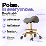 Manufakturo Selle Deep Ash Gold Base saddle stool with gas-lift adjustment, footrest ring and five castors.