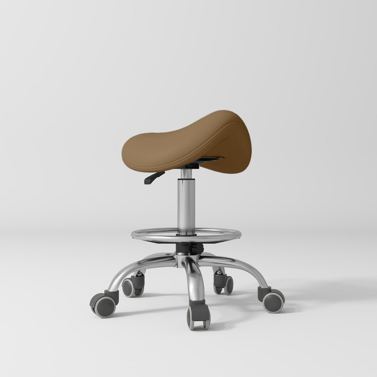 Manufakturo Selle Ergonomic Beauty Saddle Stool Caramel - Silver Base - displayed in a professional treatment-room setting