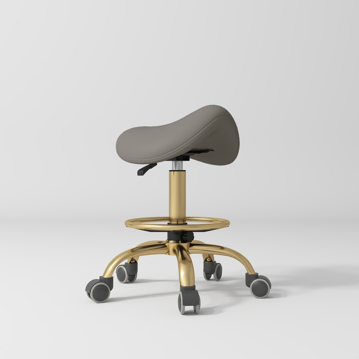 Manufakturo Selle Ergonomic Beauty Saddle Stool Deep Ash - Gold Base - displayed in a professional treatment-room setting