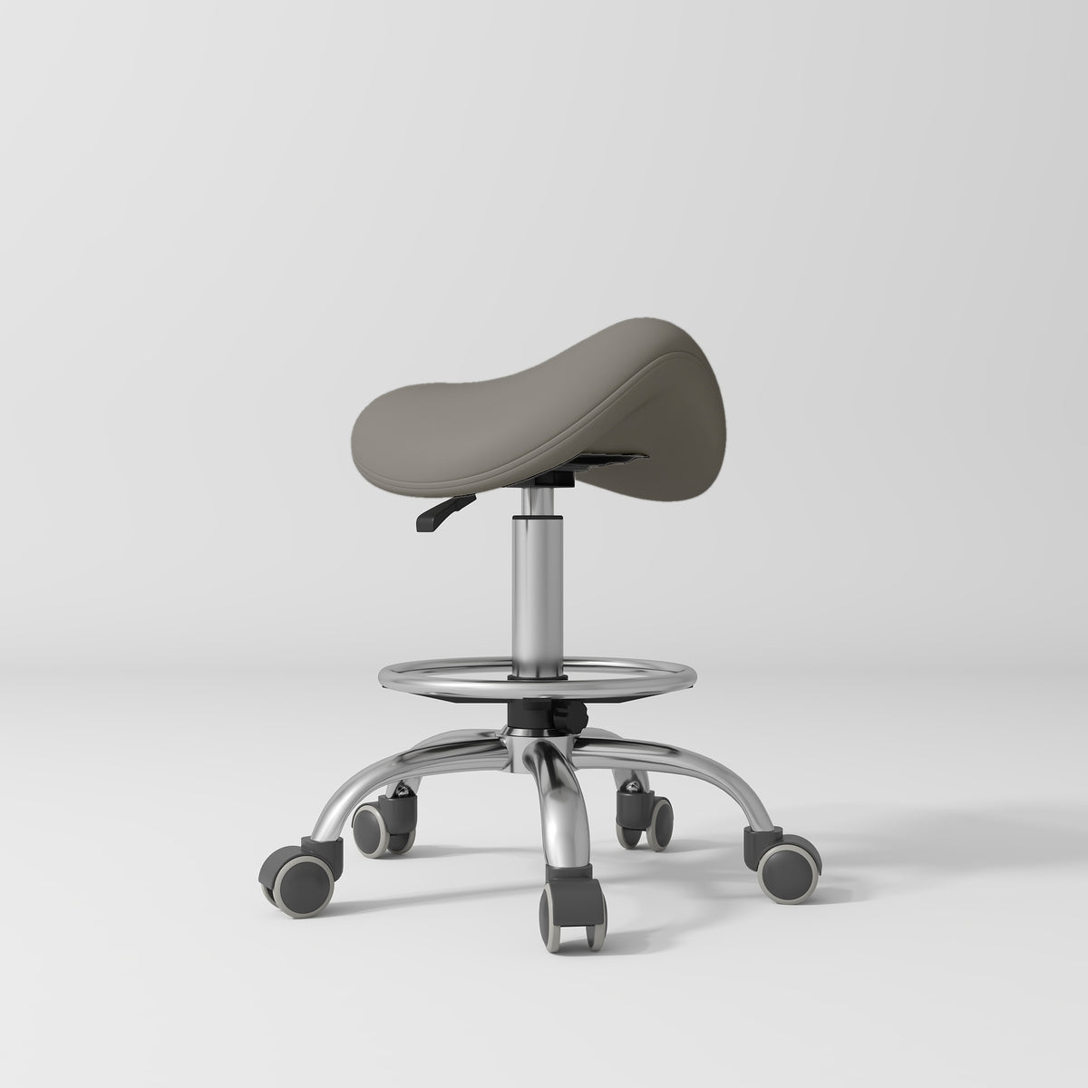 Manufakturo Selle Ergonomic Beauty Saddle Stool Deep Ash - Silver Base - displayed in a professional treatment-room setting