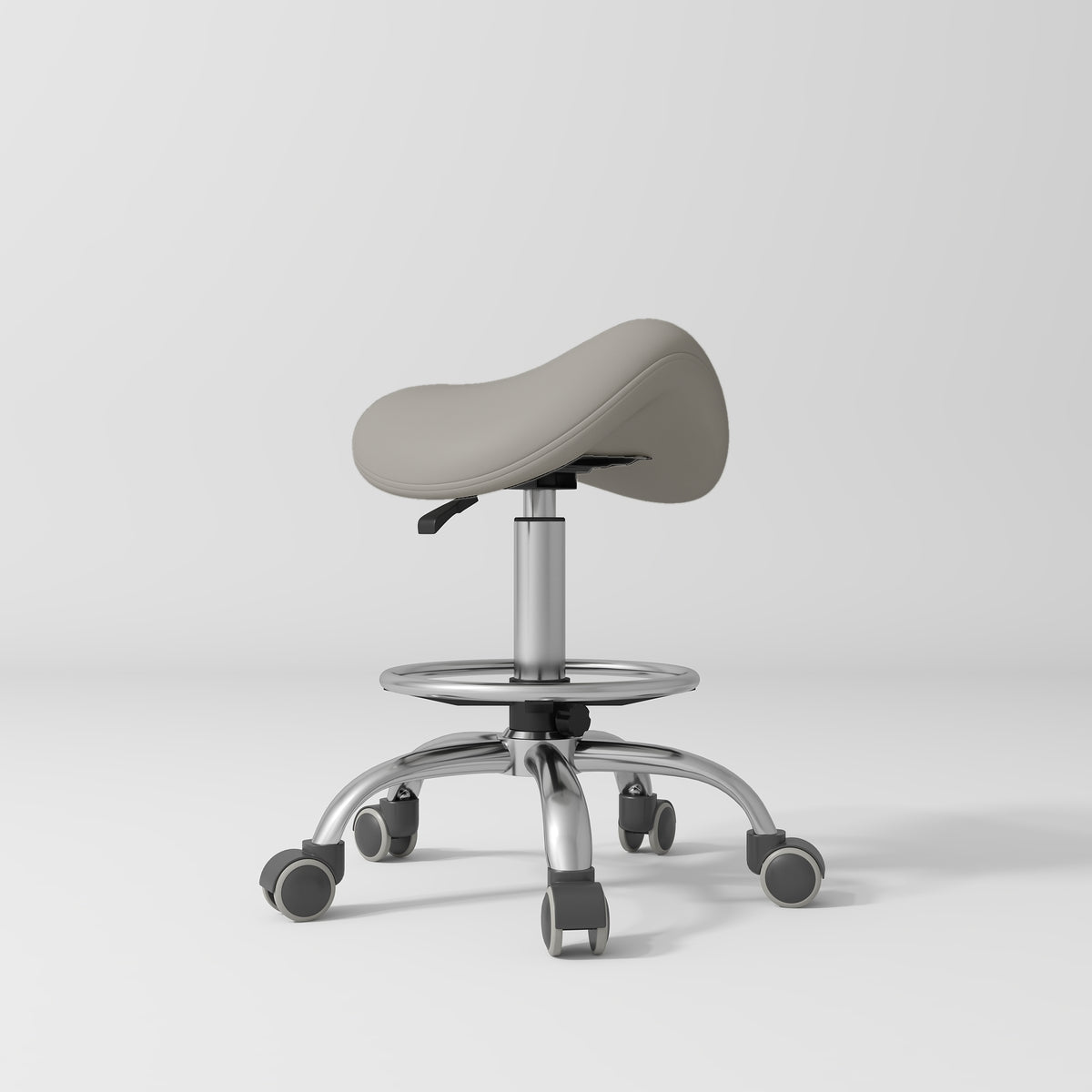 Manufakturo Selle Ergonomic Beauty Saddle Stool Pearl Greige - Silver Base - displayed in a professional treatment-room setting