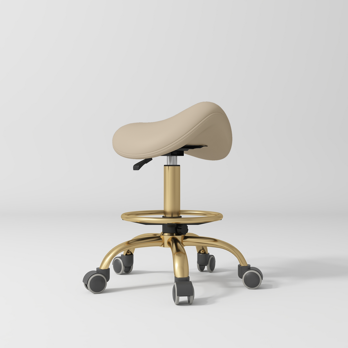 Manufakturo Selle Ergonomic Beauty Saddle Stool Warm Beige - Gold Base - displayed in a professional treatment-room setting