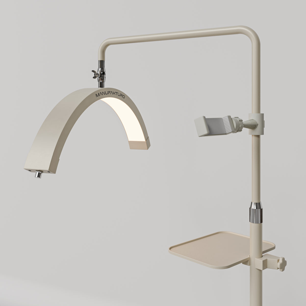 Angled view of the beige Manufakturo accessory tray mounted below the treatment lamp