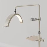Angled view of the beige Manufakturo accessory tray mounted below the treatment lamp