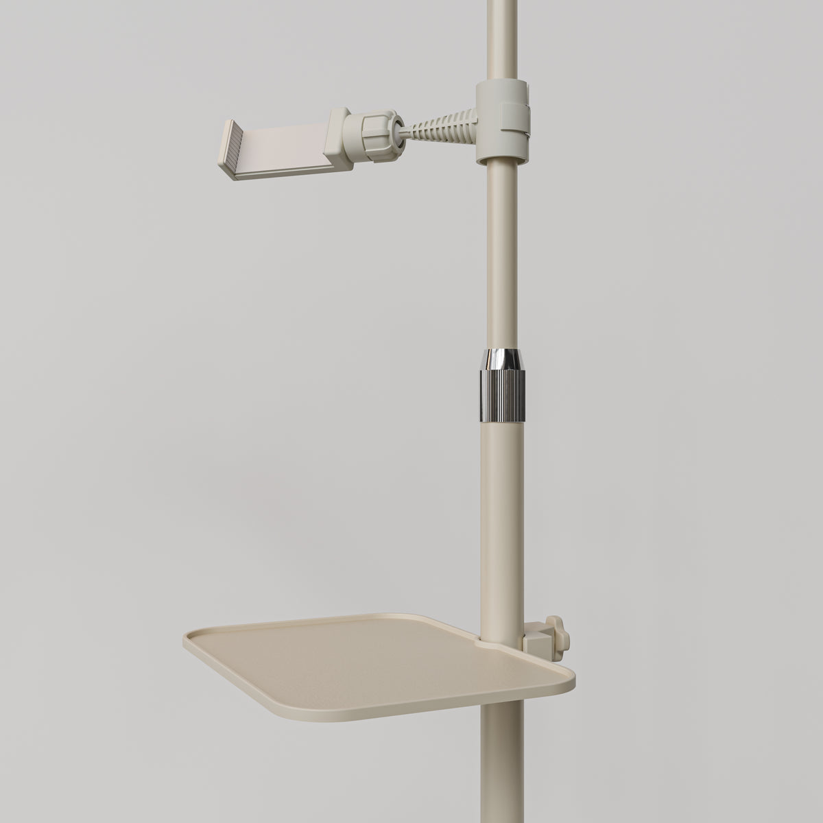Close-up of the beige Manufakturo accessory tray clamped to a treatment lamp stand