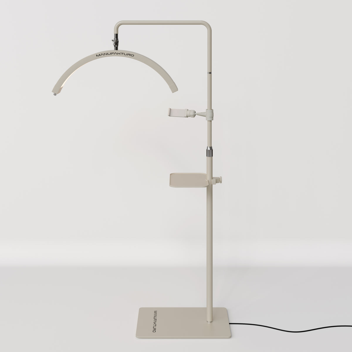 Full view of a beige Manufakturo treatment lamp with the accessory tray fitted to the stand