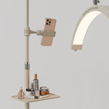 Beige Manufakturo accessory tray holding bottles and jars beside a treatment lamp with a phone in its holder