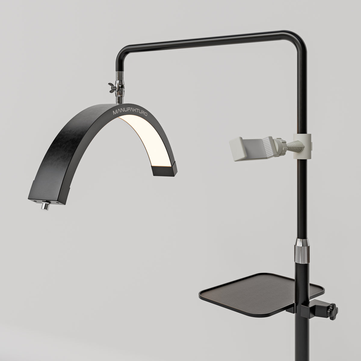 Angled view of the black Manufakturo accessory tray mounted below the treatment lamp