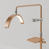 Angled view of the gold Manufakturo accessory tray mounted below the treatment lamp