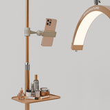 Gold Manufakturo accessory tray holding bottles and jars beside a treatment lamp with a phone in its holder