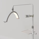 Angled view of the white Manufakturo accessory tray mounted below the treatment lamp