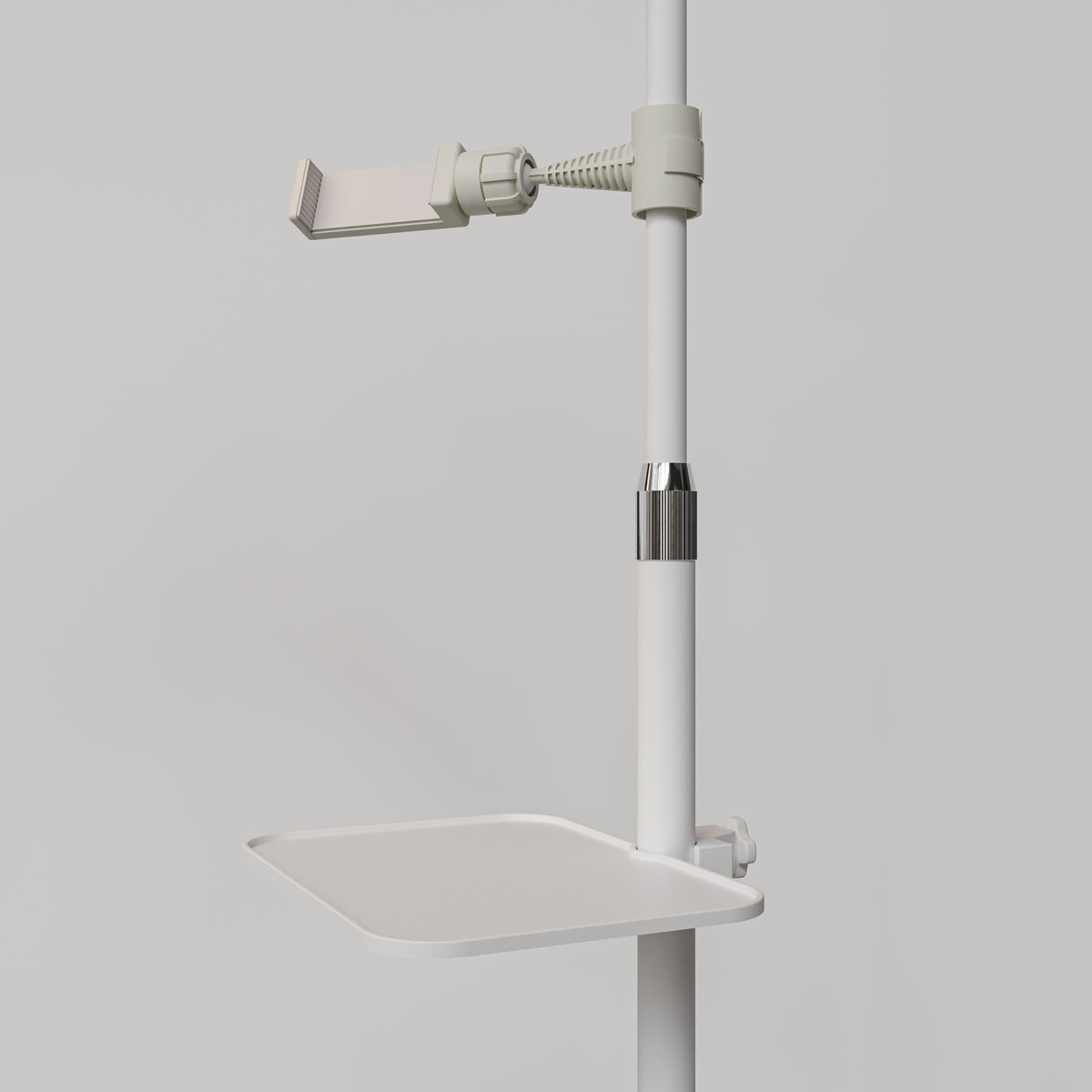 Close-up of the white Manufakturo accessory tray clamped to a treatment lamp stand