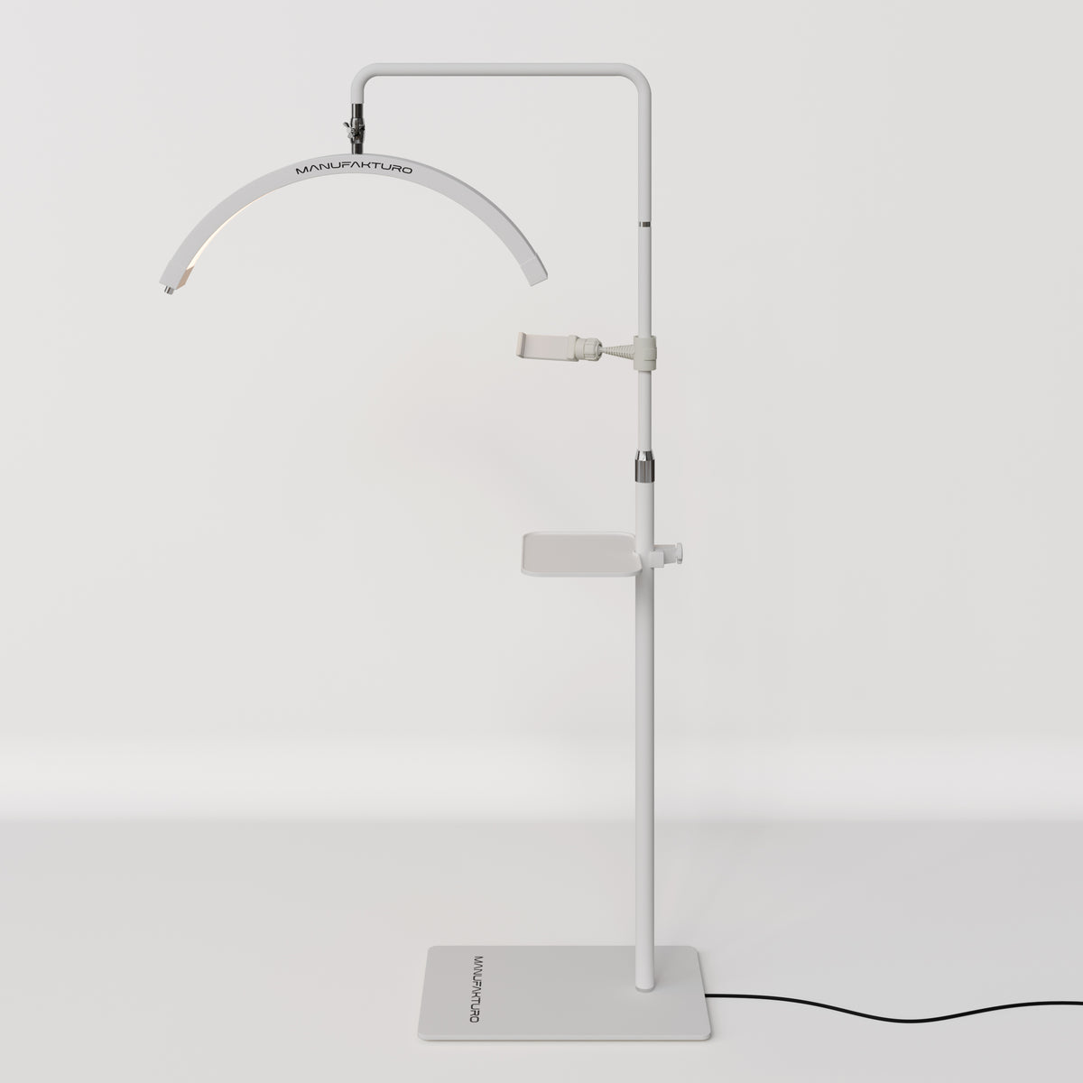 Full view of a white Manufakturo treatment lamp with the accessory tray fitted to the stand