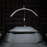 Momo MX6 curved LED lamp illuminating a salon treatment bed