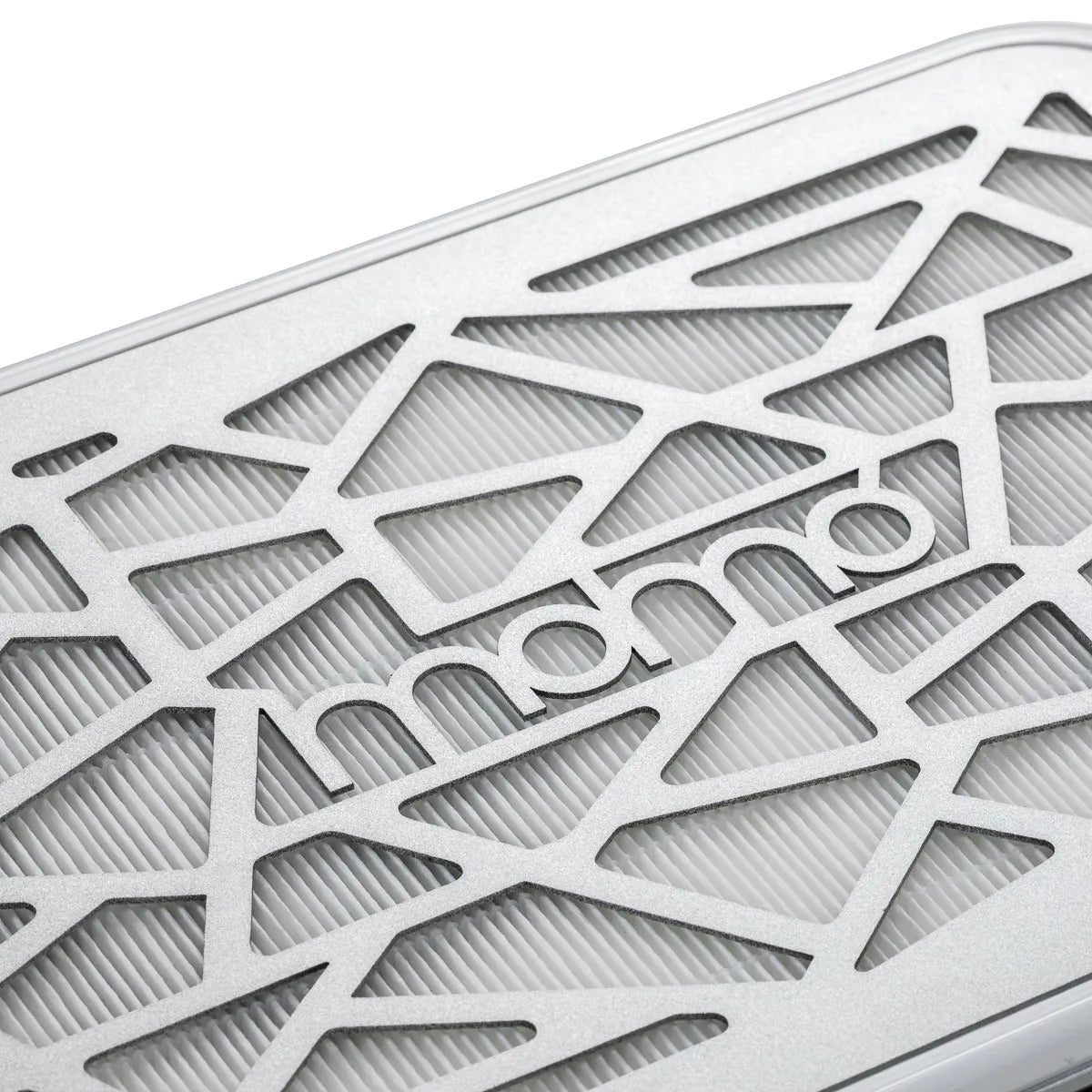 Close-up of the silver Momo logo and geometric metal intake grille on the P35 dust collector