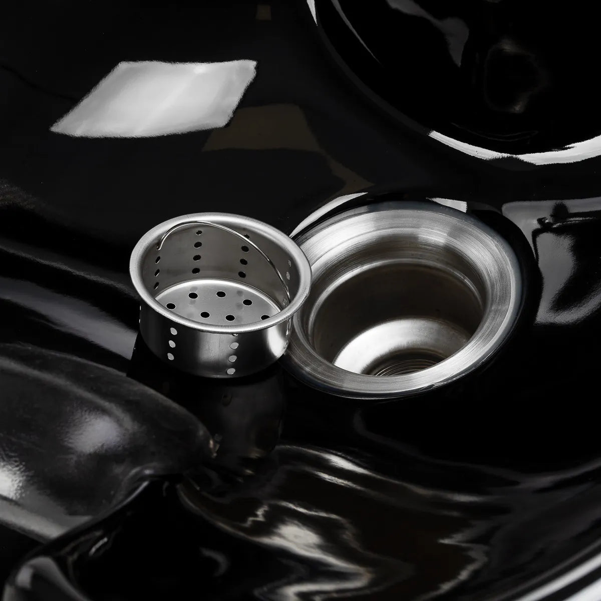 Removable stainless steel drain strainer beside the Omega Aqualina drain