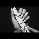 Victoria Vynn French Fighter 80/100 crescent nail file held beside a finished French manicure