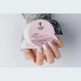 Victoria Vynn Insta Gel 11 Gold Girl pot held beside a sparkling pale pink manicure