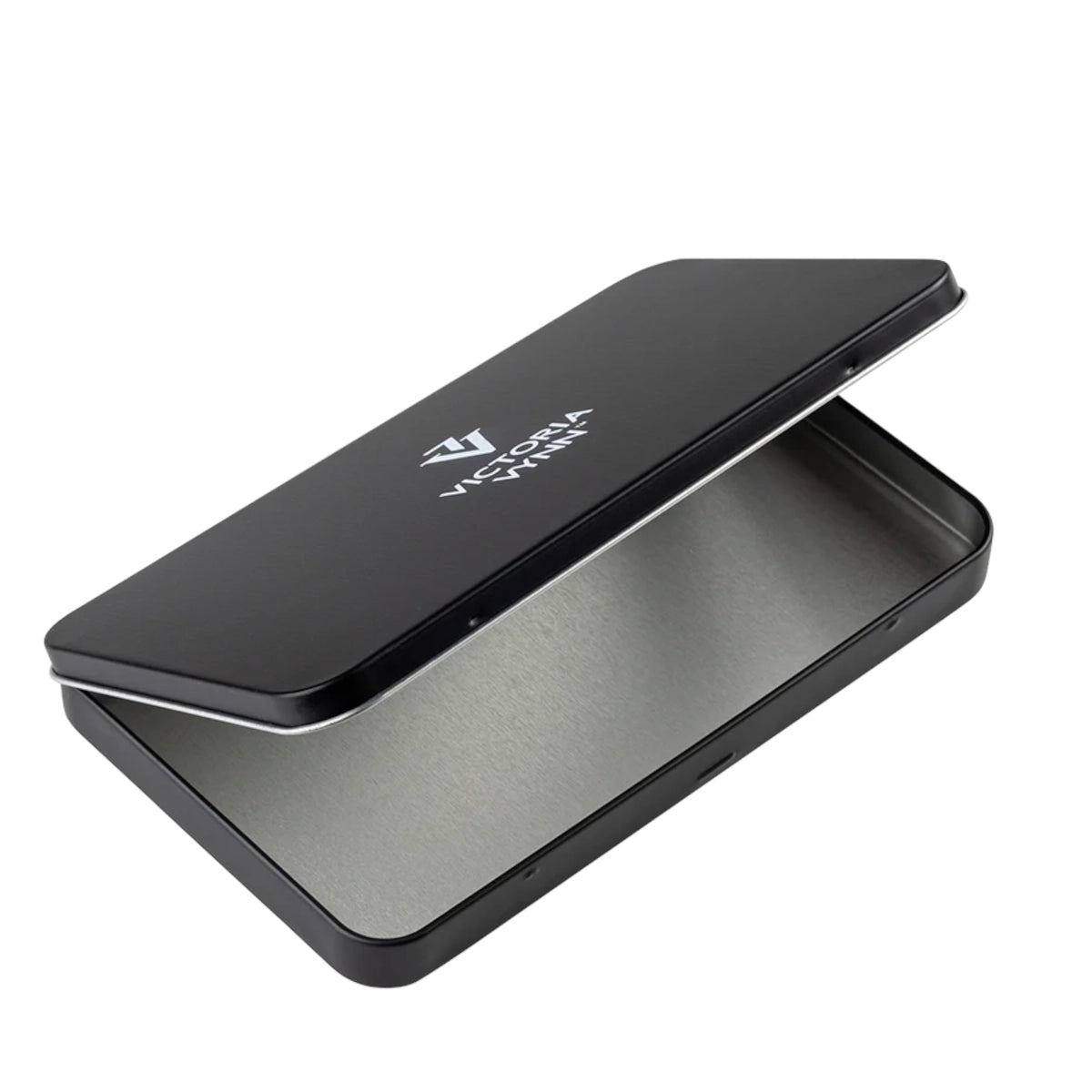 A black metal tin case with a brushed silver interior, shown open on a plain white background. The brand name 'VICTORIA VYNN' is printed in white on the lid.
