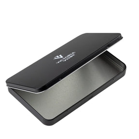 A black metal tin case with a brushed silver interior, shown open on a plain white background. The brand name 'VICTORIA VYNN' is printed in white on the lid.