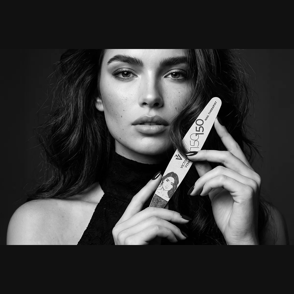 Model holding a Victoria Vynn Nail Therapist 150/150 ellipse nail file