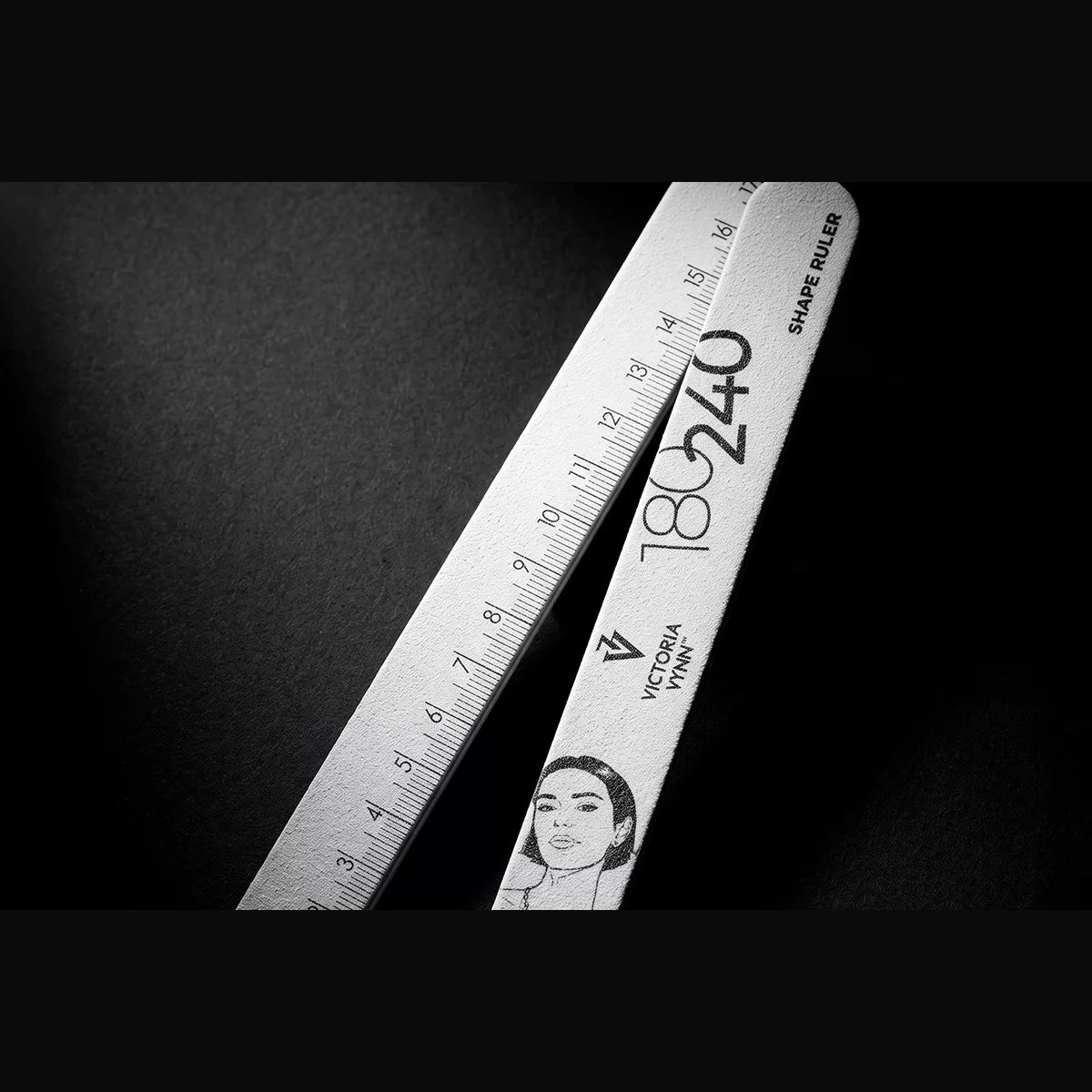 Victoria Vynn Shape Ruler 180/240 file beside its centimetre ruler edge on a black background