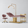 Manufakturo Chérie Dusty Rose four-piece salon set with treatment bed, matching salon chair, V3 Pro Gold lamp and empty gold three-tier beauty trolley.