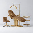 Manufakturo Étoile Caramel complete studio set with electric beauty bed, Noblesse chair, gold trolley and V3 Pro Gold treatment lamp with an aligned stand on the original grey studio background.