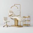 Manufakturo Étoile Creamy complete studio set with electric beauty bed, Noblesse chair, gold trolley and V3 Pro Gold treatment lamp with an aligned stand on the original grey studio background.