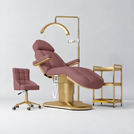 Manufakturo Étoile Dusty Rose complete studio set with electric beauty bed, Noblesse chair, gold trolley and V3 Pro Gold treatment lamp with an aligned stand on the original grey studio background.