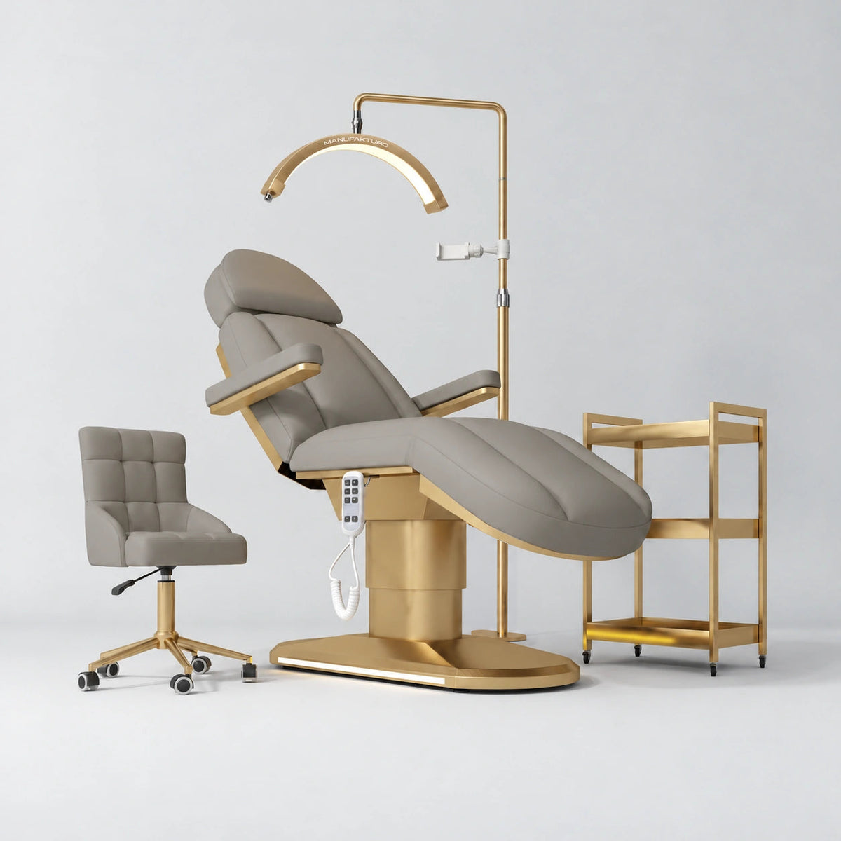Manufakturo Étoile Pearl Greige complete studio set with electric beauty bed, Noblesse chair, gold trolley and V3 Pro Gold treatment lamp with an aligned stand on the original grey studio background.