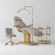 Manufakturo Étoile Stone Taupe complete studio set with electric beauty bed, Noblesse chair, gold trolley and V3 Pro Gold treatment lamp with an aligned stand on the original grey studio background.