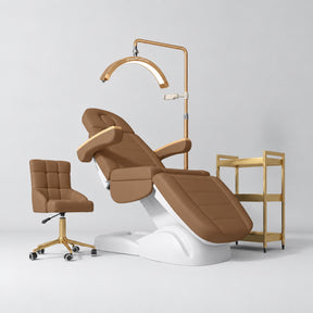Manufakturo Grace Caramel four-piece salon set with treatment bed, matching salon chair, V3 Pro Gold lamp and empty gold three-tier beauty trolley.