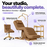 Manufakturo Grandeur Caramel four-piece salon set features: treatment bed, matching salon chair, V3 Pro Gold lamp and gold three-tier beauty trolley.