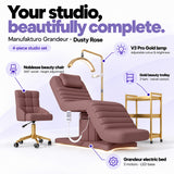 Manufakturo Grandeur Dusty Rose four-piece salon set features: treatment bed, matching salon chair, V3 Pro Gold lamp and gold three-tier beauty trolley.