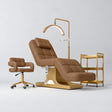 Manufakturo Saphir version A Caramel four-piece salon set with treatment bed, matching salon chair, V3 Pro Gold lamp and empty gold three-tier beauty trolley.
