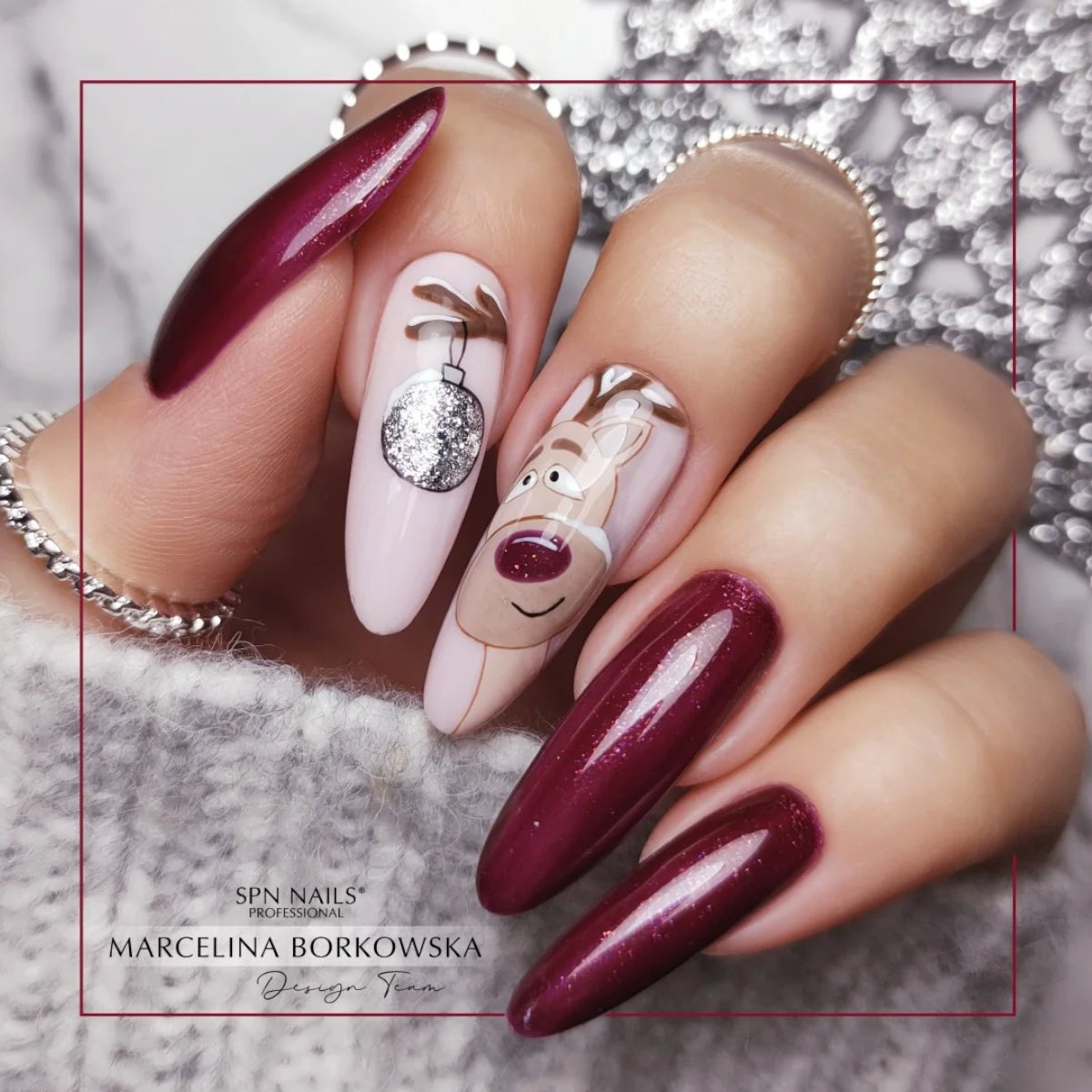 Manicure featuring SPN Nails UV/LED Gel Polish 657 Sober with glittery red nails and festive nail art, showcasing its vibrant finish.