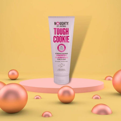 Noughty Tough Cookie Strenghtening Shampoo on podium