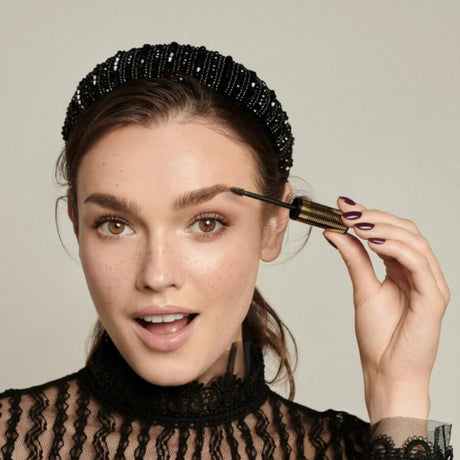 Eveline Brow & Go Eyebrow Mascara - product displayed with its packaging on a dark background
