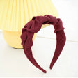 Roxie Cosmetics Burgundy Crinkle Headband - displayed in a styled studio photograph