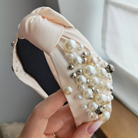 Roxie Cosmetics Classic Headband Creamy With Pearls - product displayed with its packaging on a dark background