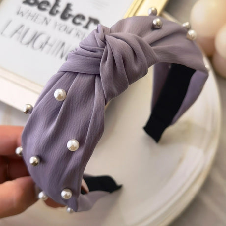 Roxie Cosmetics Classic Headband Violet With Pearls - product displayed with its packaging on a dark background