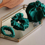 Roxie Cosmetics Luxe 100% Mulberry Silk 30 Momme Scrunchie Bottle Green - product displayed with its packaging on a dark background