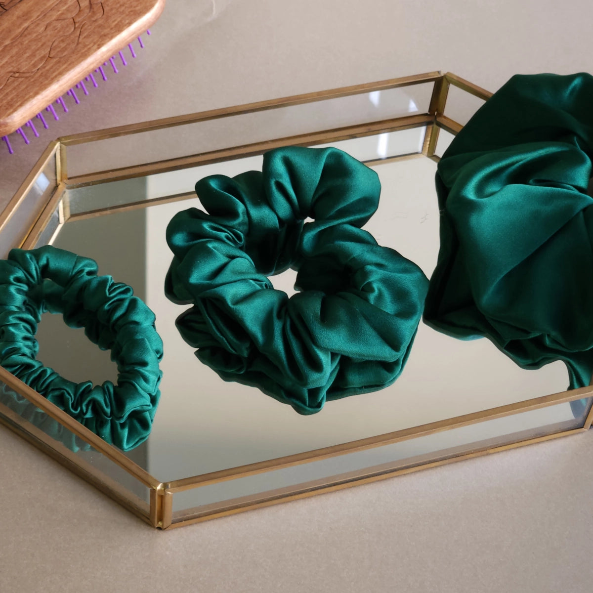 Roxie Cosmetics Luxe 100% Mulberry Silk 30 Momme Scrunchie Bottle Green - product displayed with its packaging on a dark background