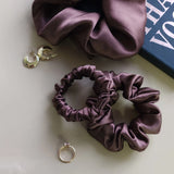 Roxie Cosmetics Luxe 100% Mulberry Silk 30 Momme Scrunchie Chocolate Brown - product displayed with its packaging on a dark background